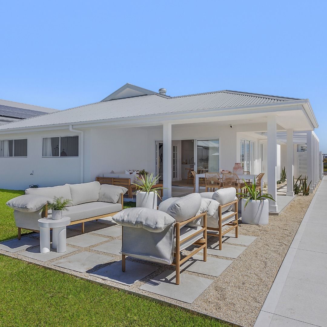 White House Exterior with Patio Furniture on Concrete Pavers and Gravel — Hunter Home Services in Lake Macquarie, NSW