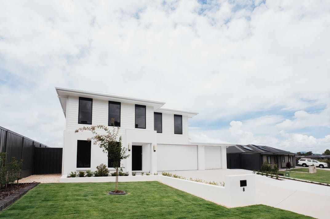 White Two-Story House with Black Windows, a Garage — Hunter Home Services in Cessnock, NSW