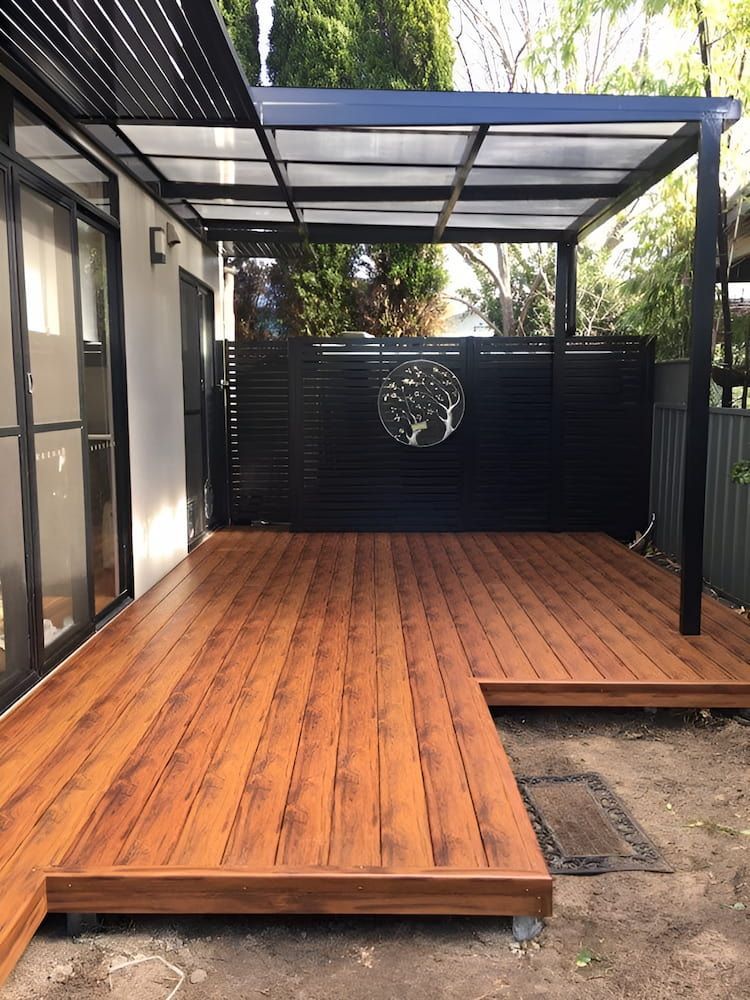 A Wooden Deck With A Pergola Over It In A Backyard — Hunter Home Services in Huntlee, NSW