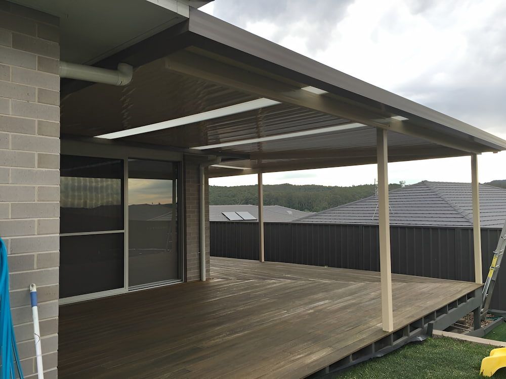 A House With A Wooden Deck And A Canopy Over It — Hunter Home Services in Heddon Greta, NSW