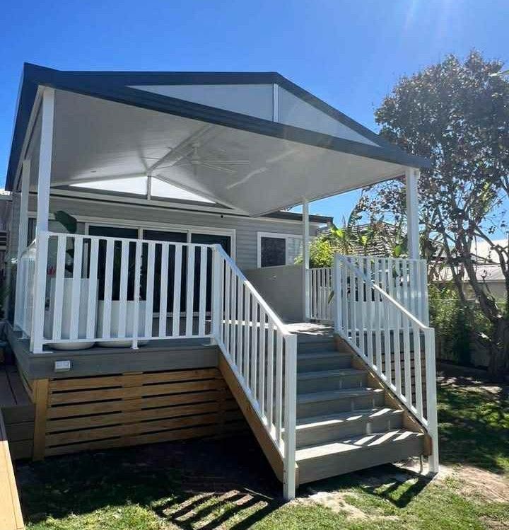 Small House with White Railing and Stairs, Covered Deck with White Roof, Sunny Day — Hunter Home Services in Maitland, NSW