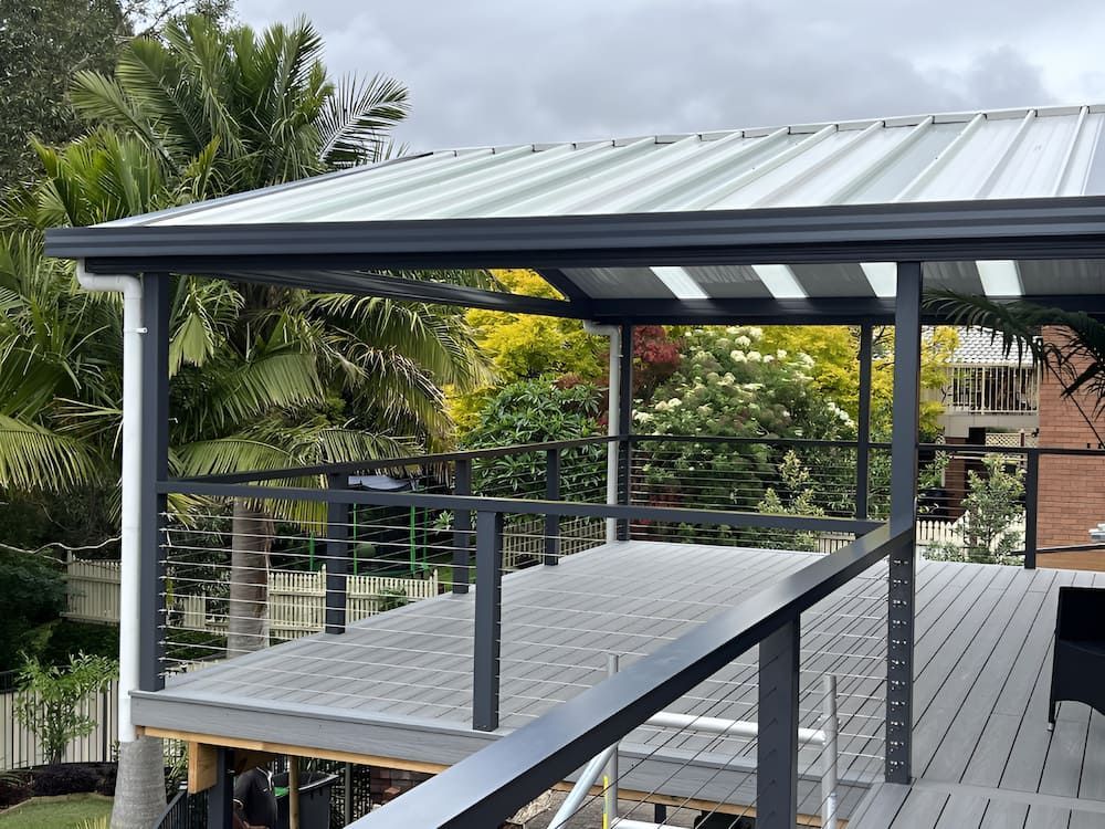 A Wooden Deck With A Metal Roof And A Metal Railing — Hunter Home Services in Thornton, NSW