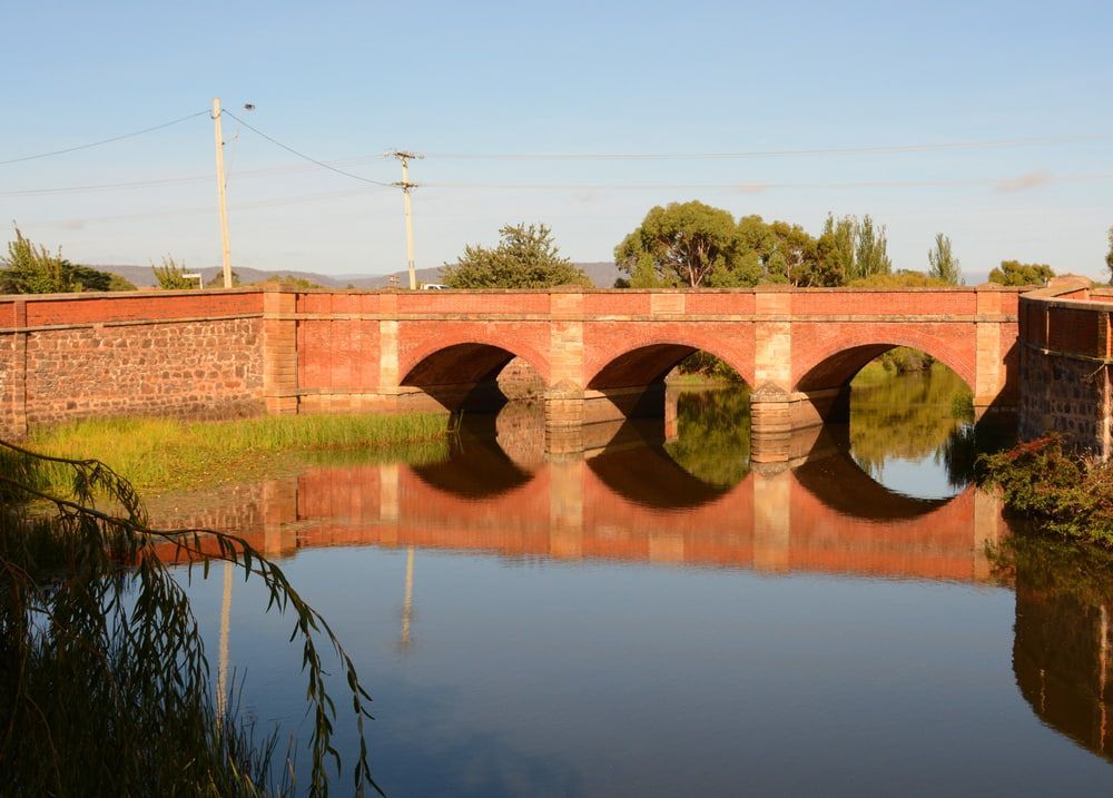 A Bridge Over a Body of Water with Trees in The Background — Leisure Coast Powder Coaters in Campbelltown, NSW