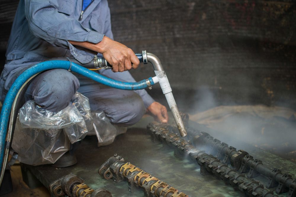 Worker Is Cleaning the Machine Equipment — Leisure Coast Powder Coaters in Unanderra, NSW