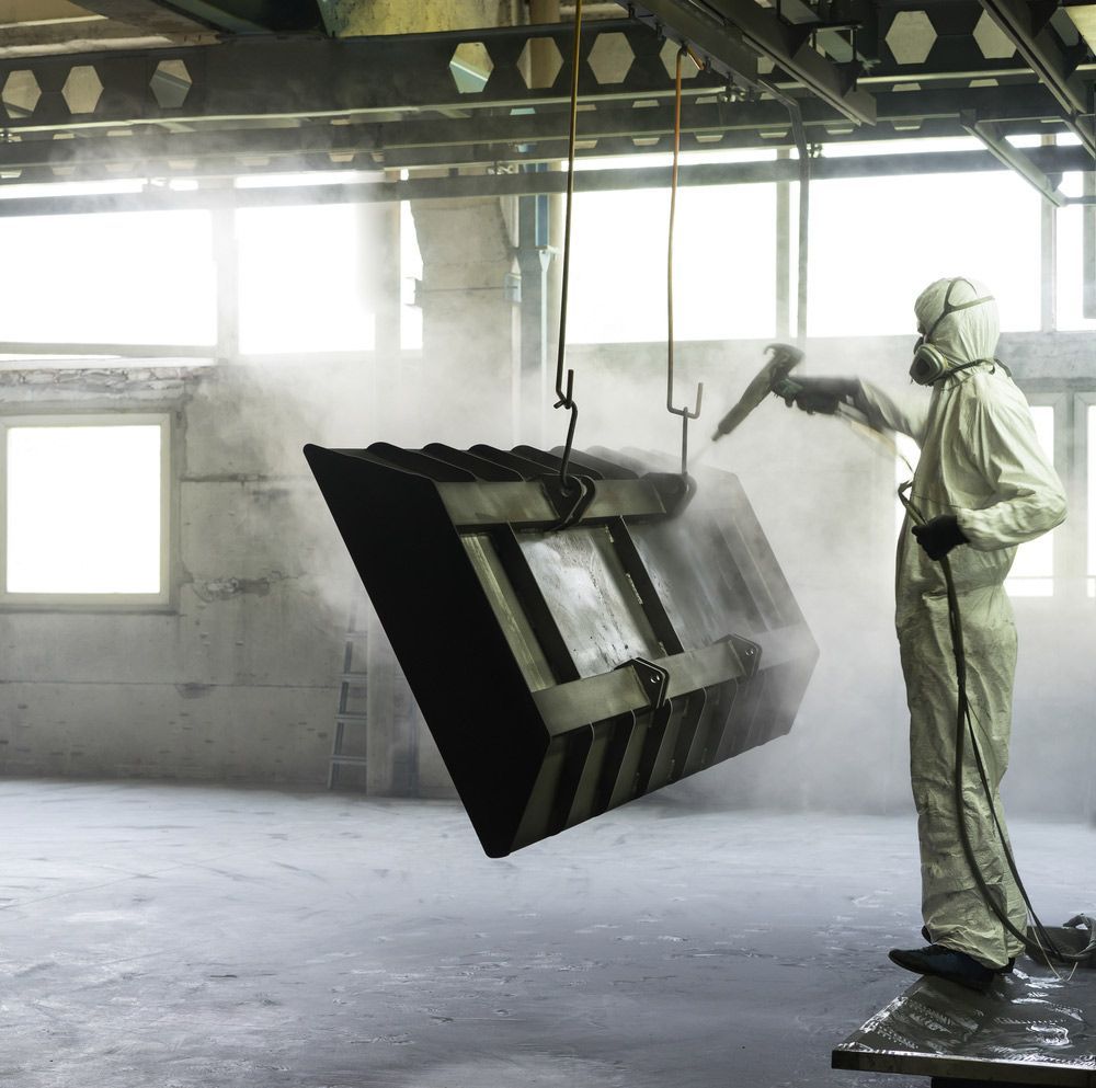 Sand Blasting a Metal Crate Hung from A Metal Beam — Leisure Coast Powder Coaters in Unanderra, NSW