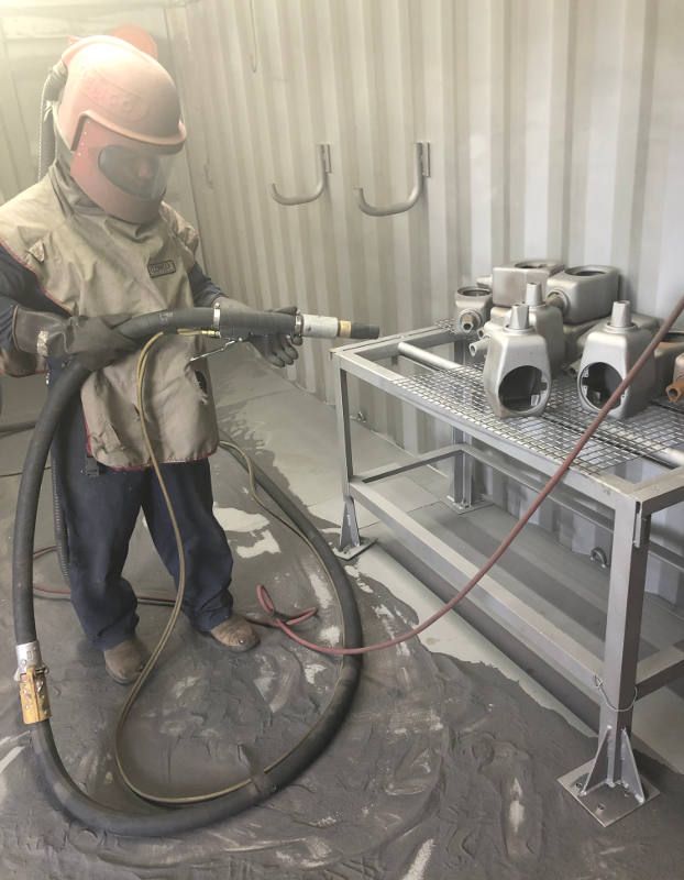 Worker Working for Sandblasting While Wearing Safety Gear — Leisure Coast Powder Coaters in Unanderra, NSW