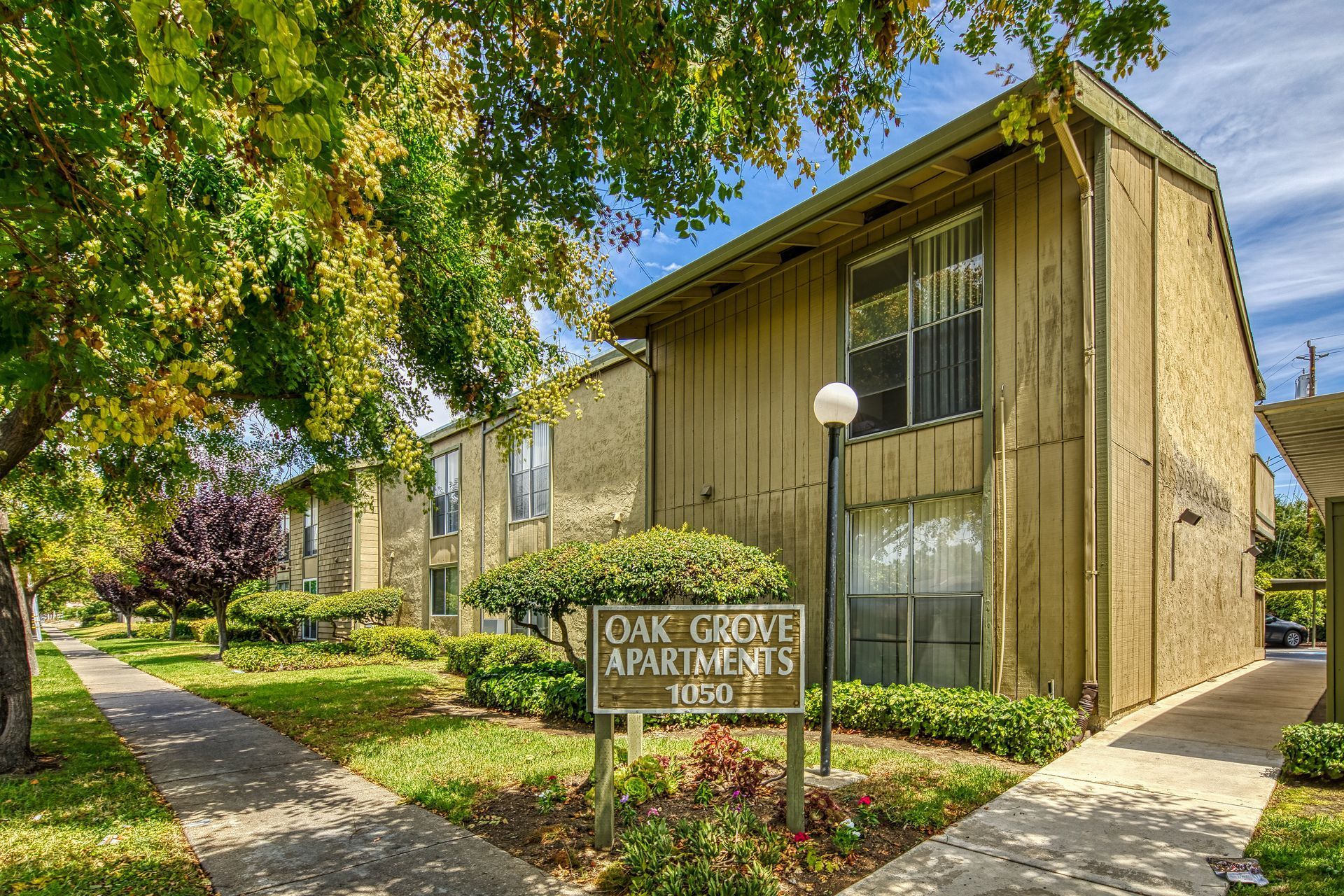 A large apartment building with a sign in front of it.