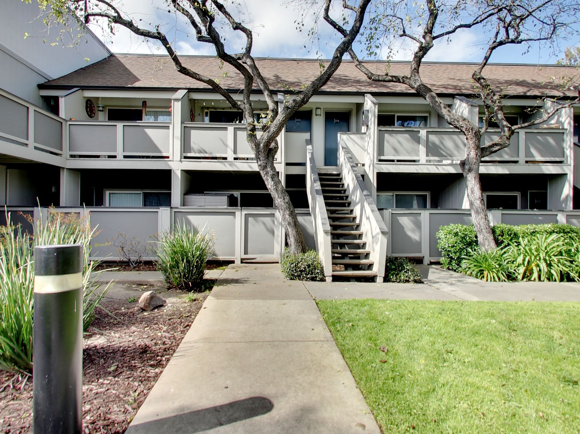 A building with stairs leading up to the second floor