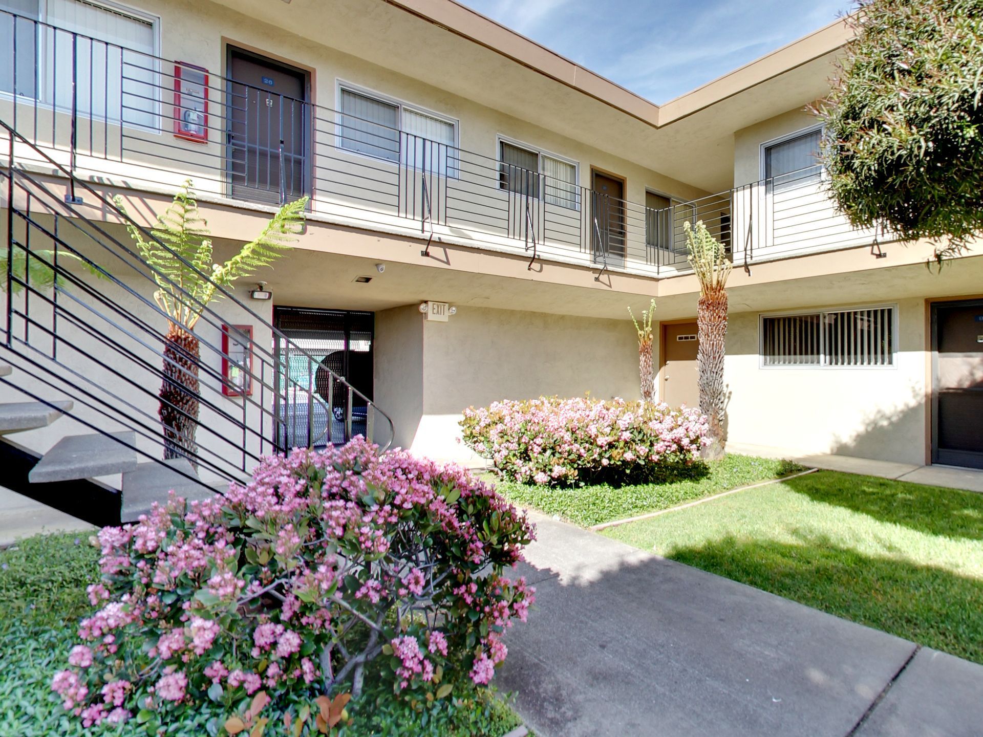 A building with stairs and flowers in front of it