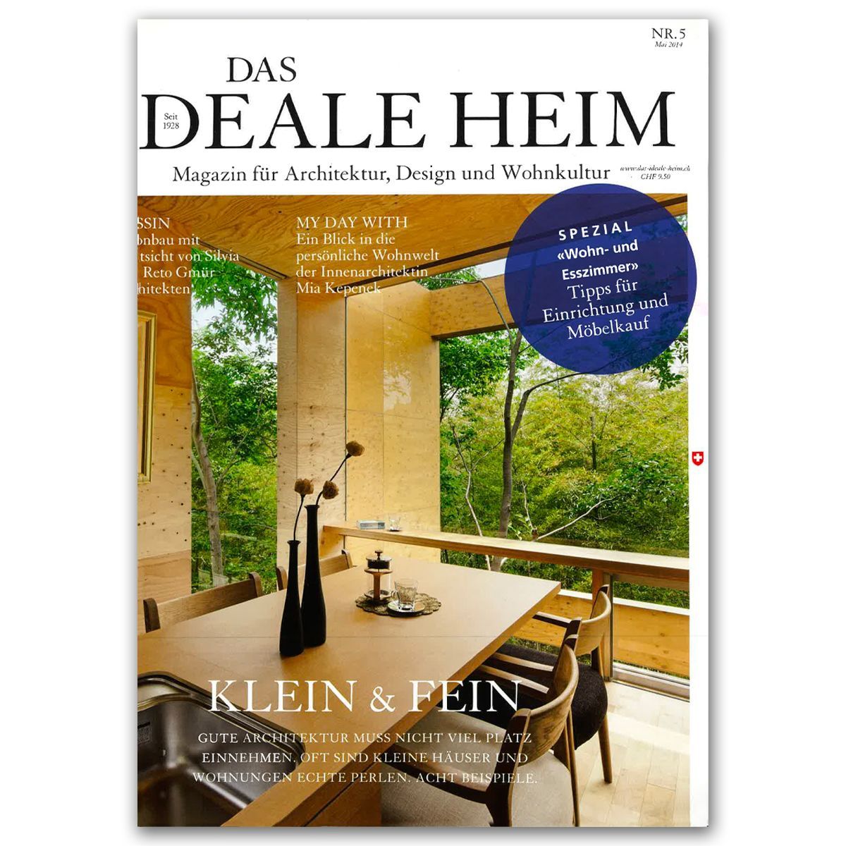 Copertina di una rivista con una moderna sala da pranzo con vista sulla foresta. Testo: 