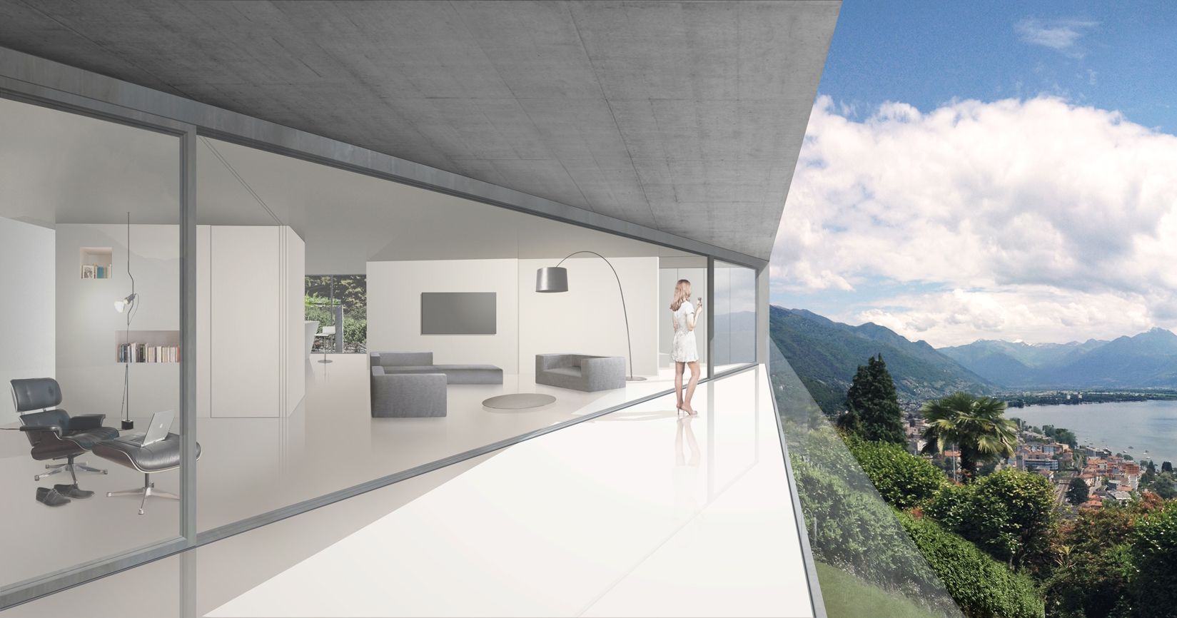 Interno di una casa moderna e bianca con finestre panoramiche che si affacciano su un lago e sulle montagne. Grande balcone.