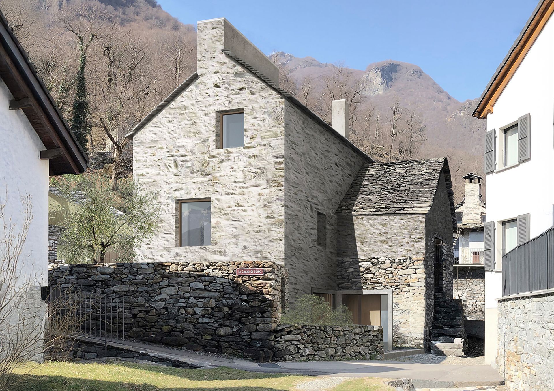 Edificio in pietra con finestre e camino, catasta di legna accatastata, circondato da altri edifici, sullo sfondo montagne.