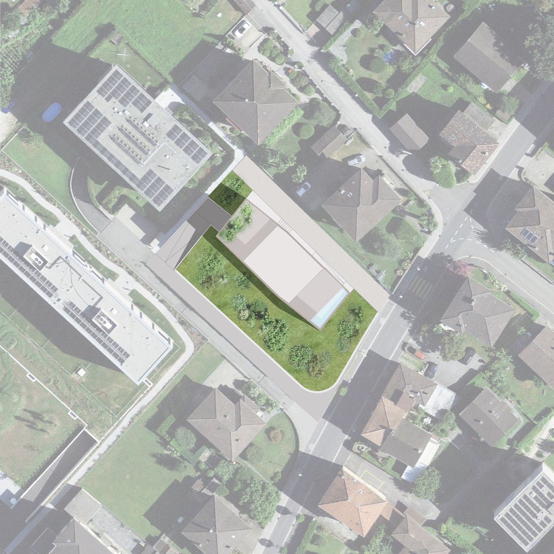 Vista dall'alto di un edificio moderno con giardino verde in mezzo a una zona residenziale con strade e case.