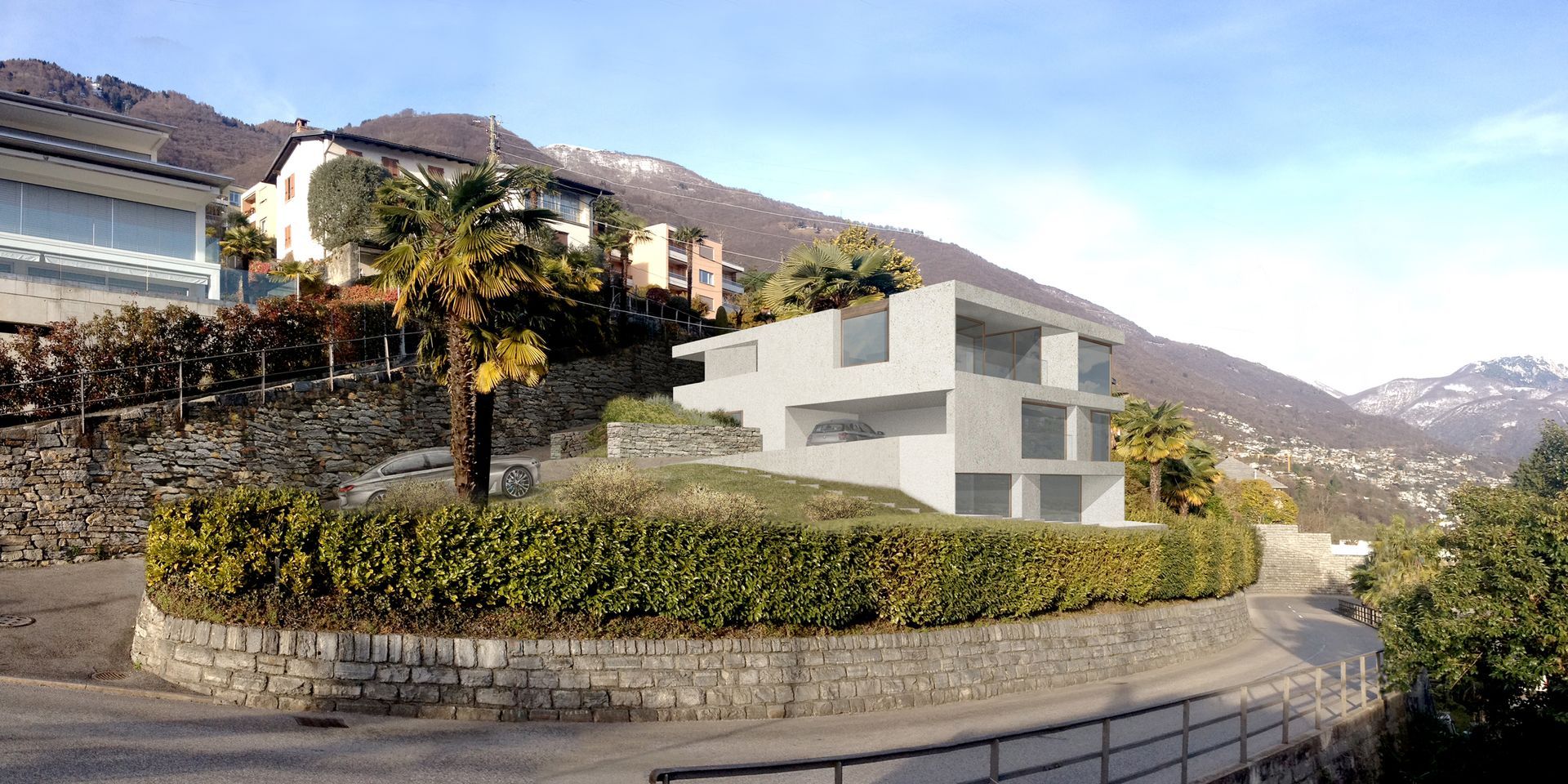 Un moderno edificio a più piani sorge su una collina. È circondato da montagne e vegetazione, sotto un cielo azzurro.