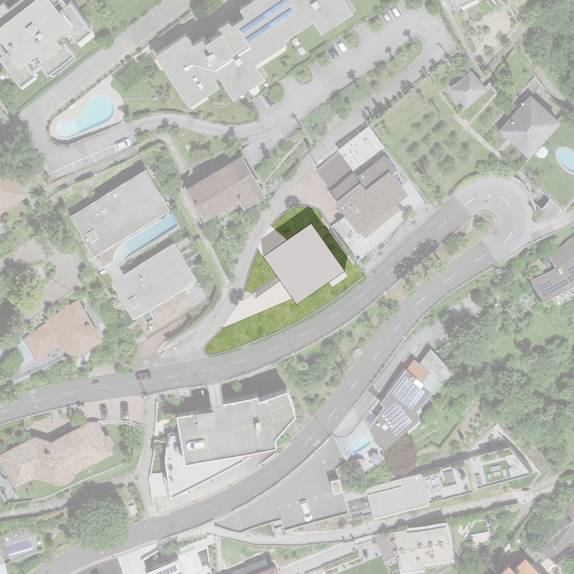 Vista aerea di un edificio circondato da strade e alberi su una collina.