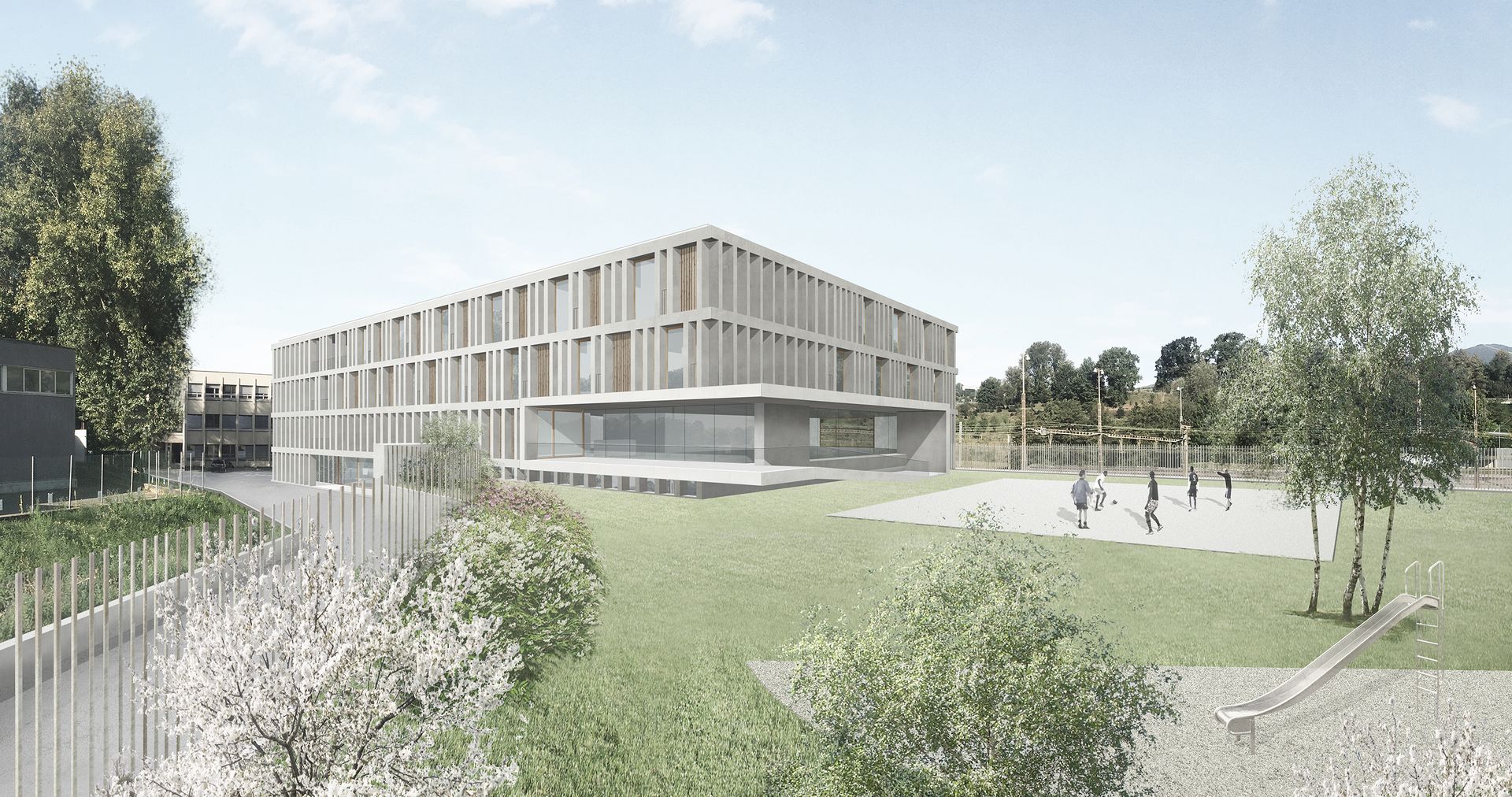 Moderno edificio di tre piani con parco giochi e area erbosa antistante.