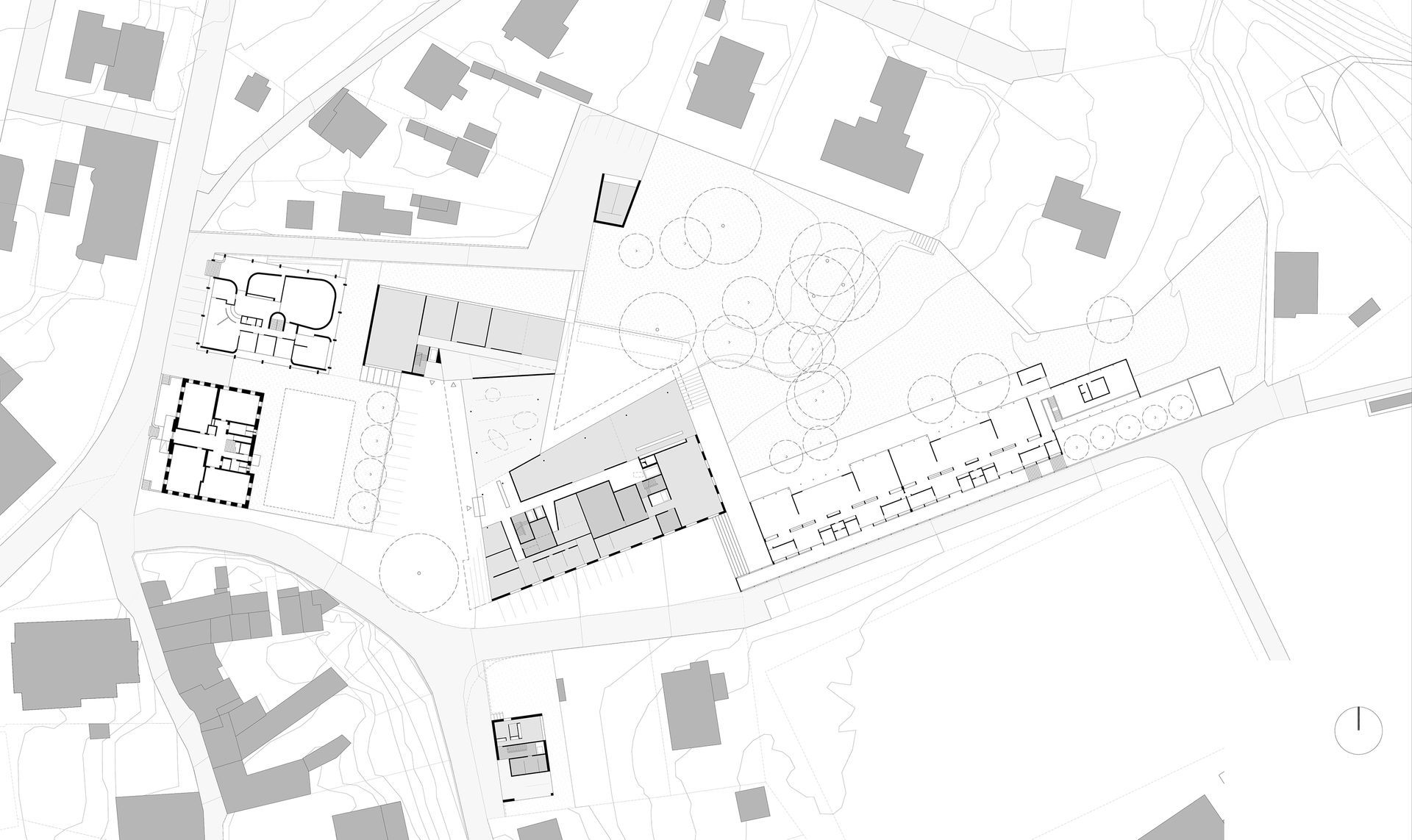 Mappa architettonica dall'alto di edifici e strade, rappresentata in tonalità di grigio.