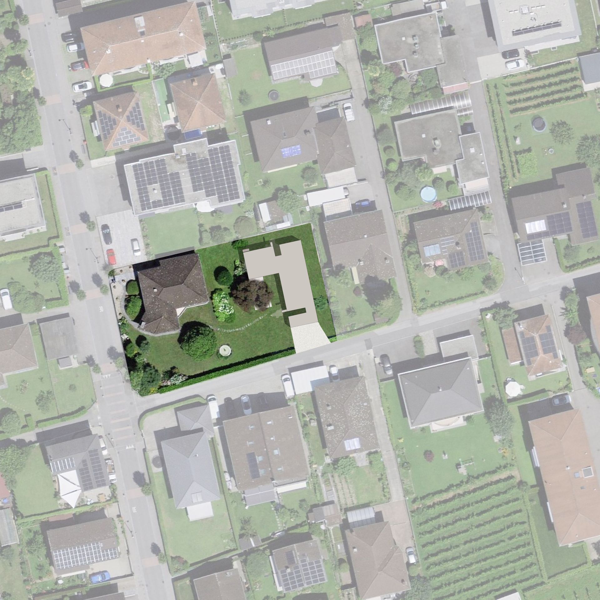 Vista aerea di un quartiere residenziale con case, strade e spazi verdi. Una casa è evidenziata in verde.