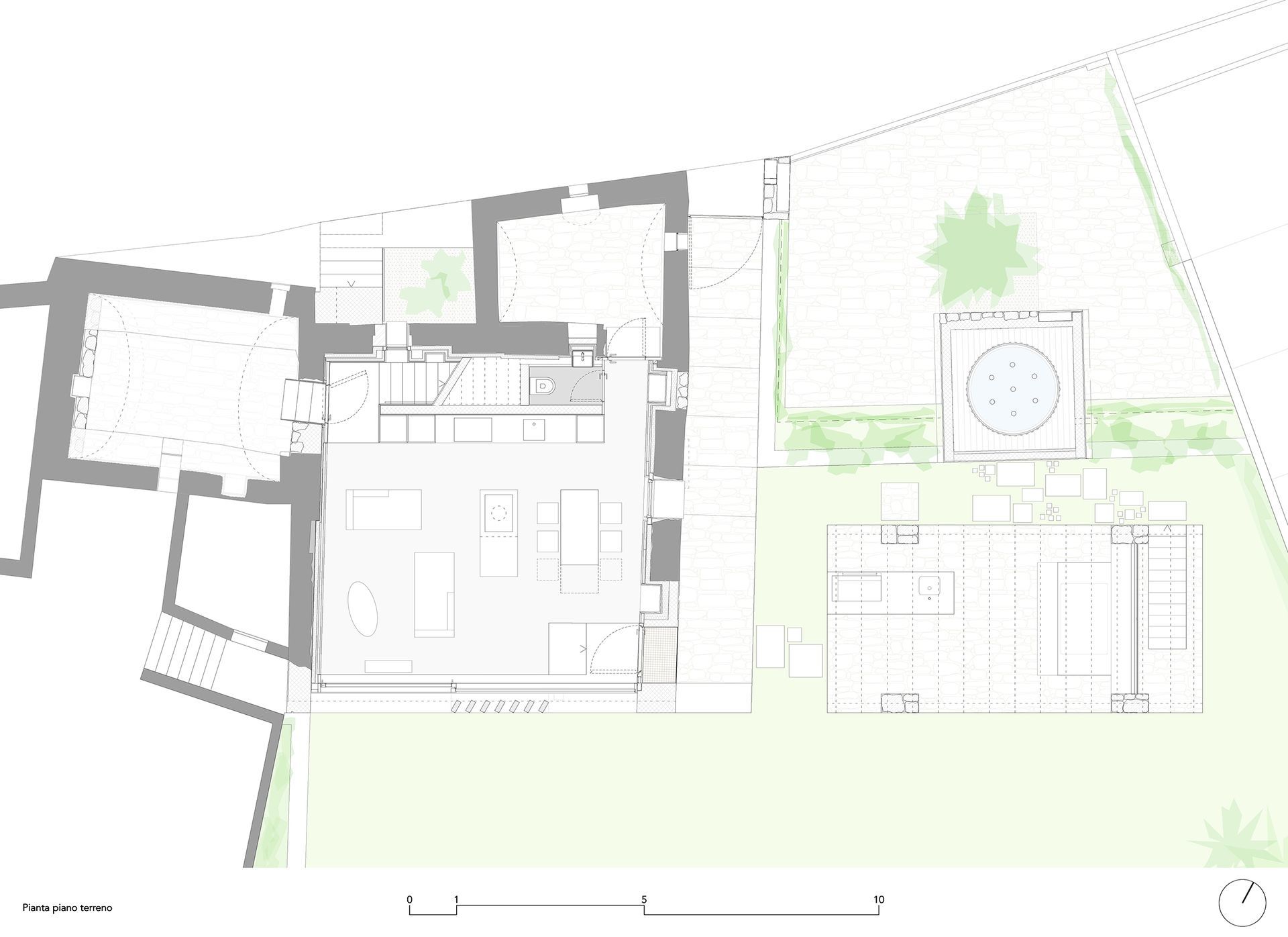 Planimetria architettonica in scala di grigi, che mostra edifici e paesaggio con un idromassaggio circolare.