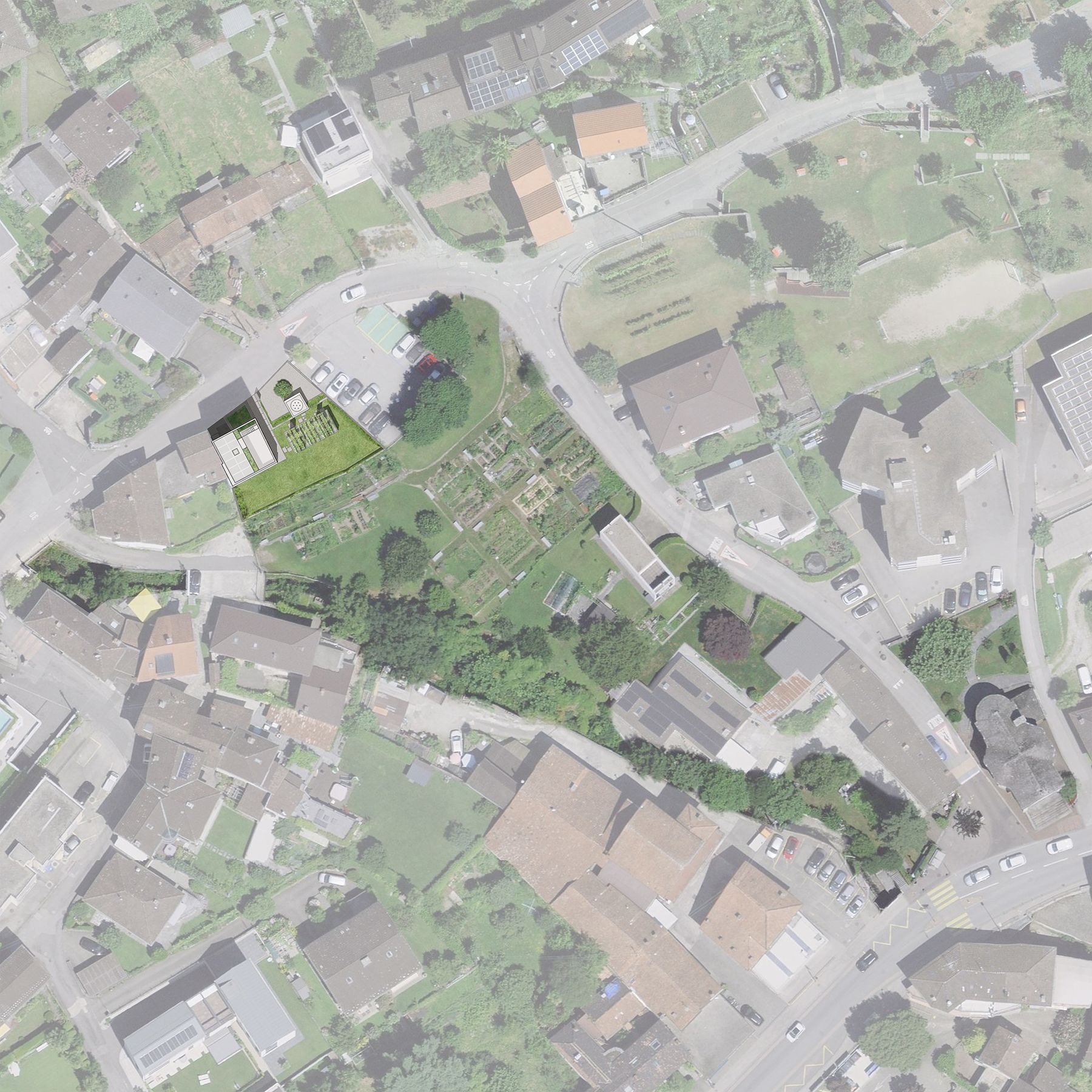 Vista aerea di una zona residenziale con edifici, strade e un ampio spazio verde.