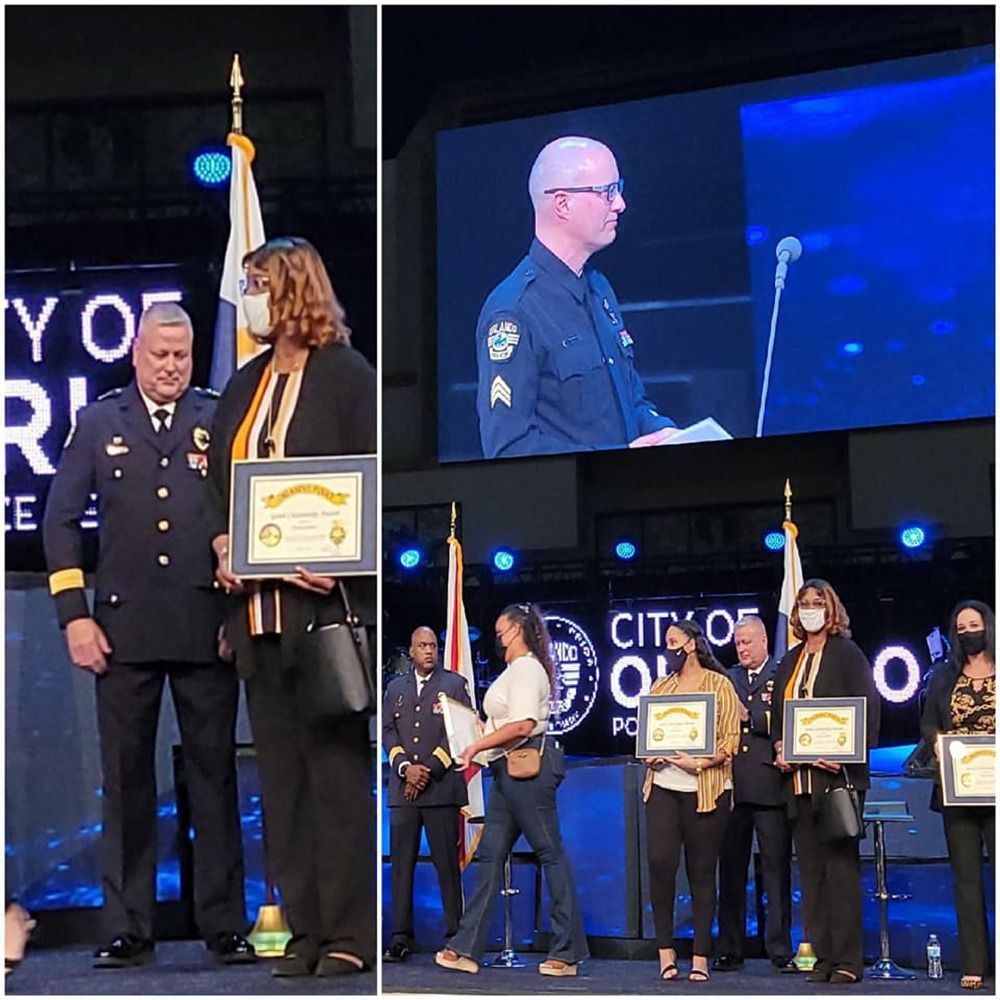 Award ceremony: officials presenting certificates on stage.