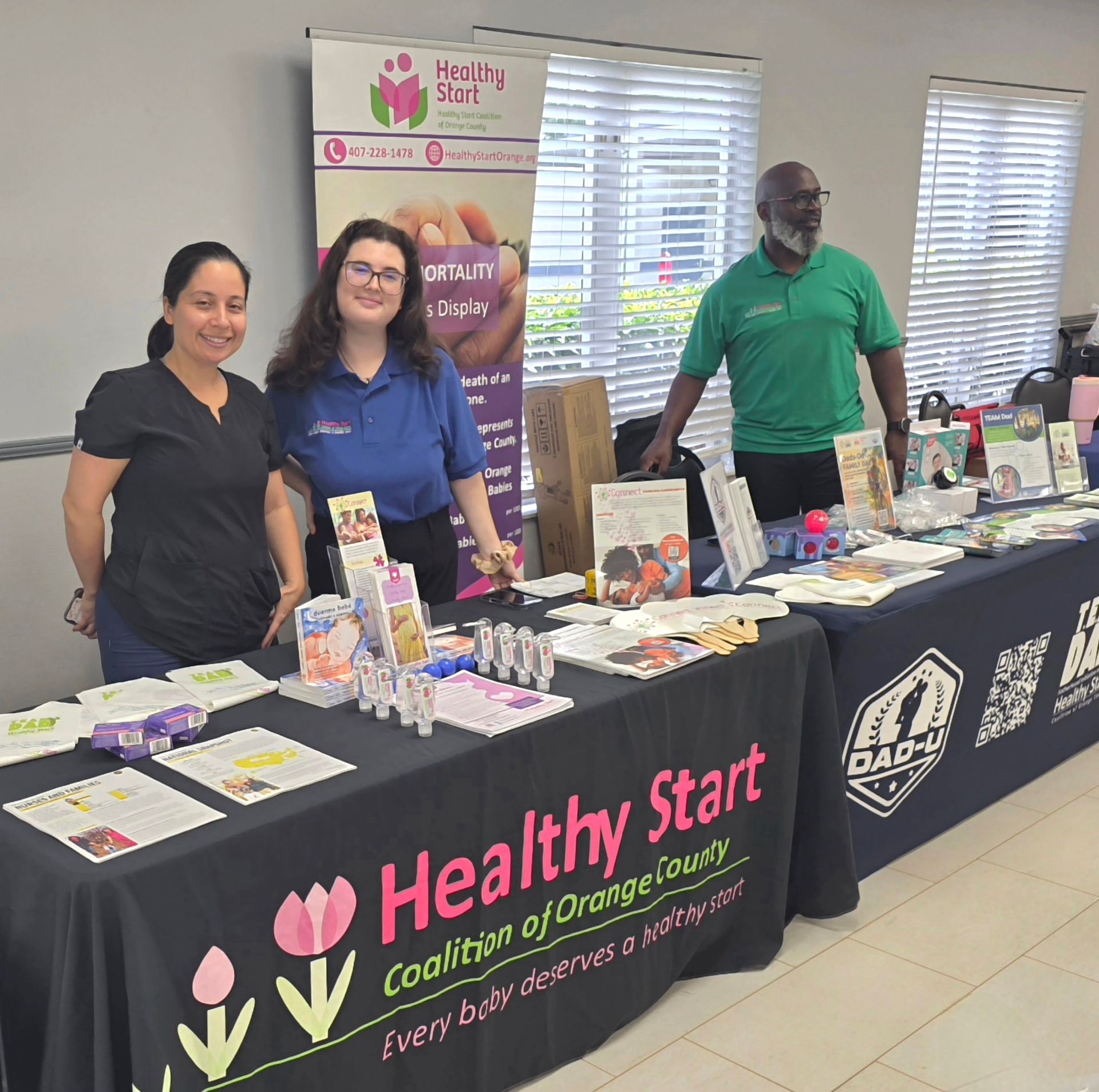 Healthy Start health fair booth with three staff behind tables displaying brochures, products, and banners.