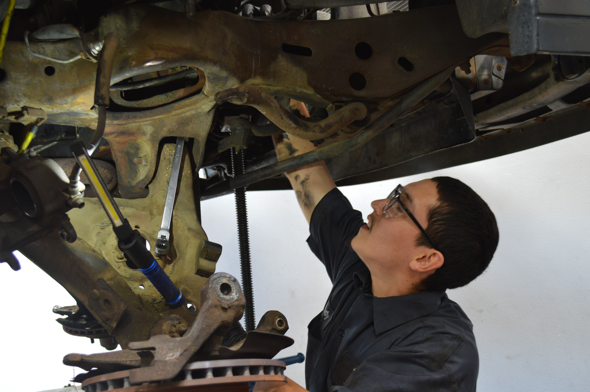 Expert Technician working on underneath of car | Redhawk Auto Service