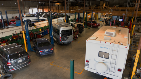 Silver car propped up in garage | Redhawk Auto Service