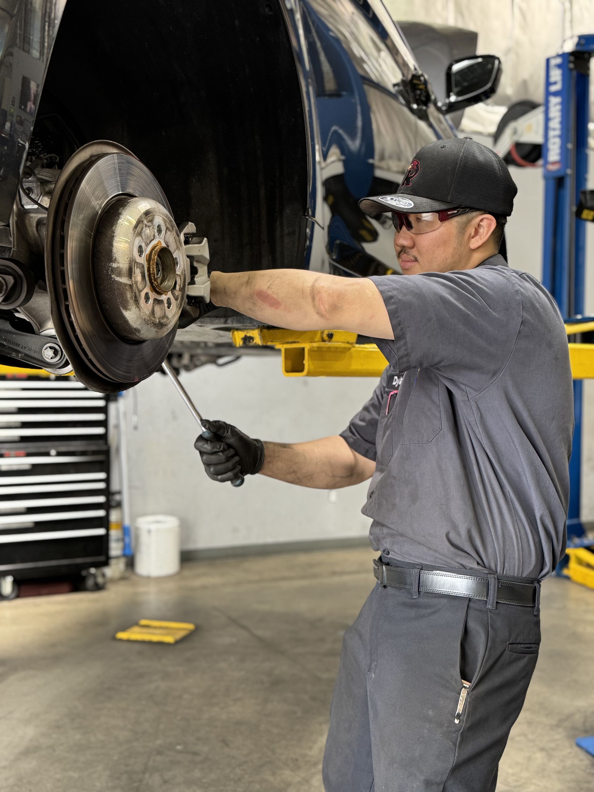 Technician working on brake system | Redhawk Auto Service