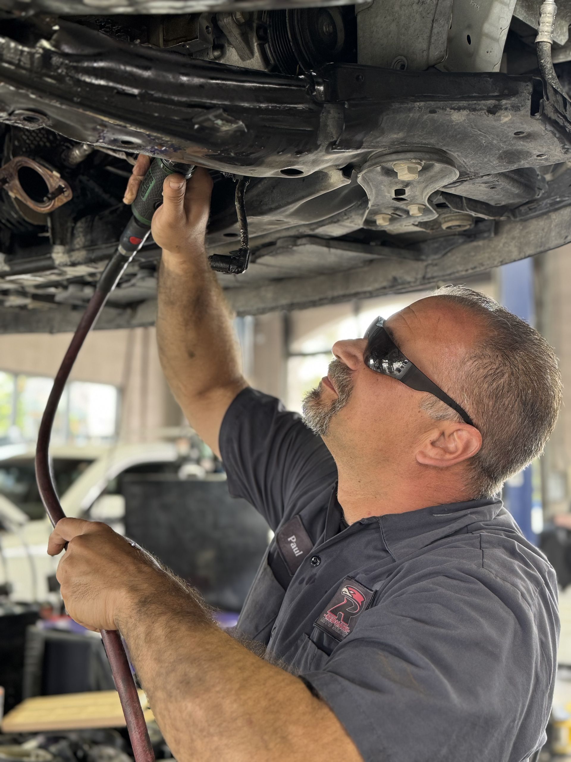 Expert Technician working on underneath of car | Redhawk Auto Service