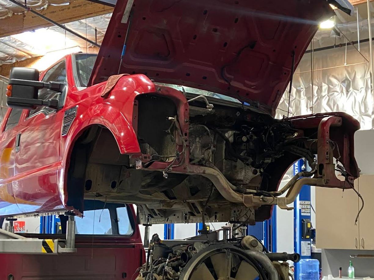 Red vehicle repair in progress | Redhawk Auto Service