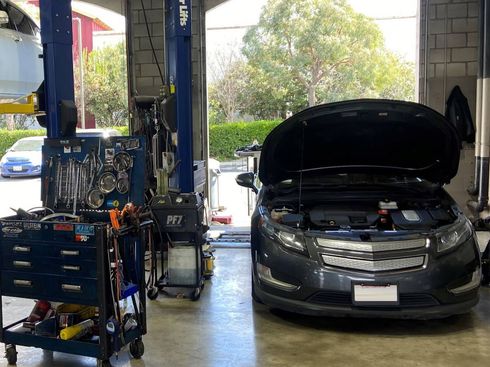 Car with hood up in garage | Redhawk Auto Service