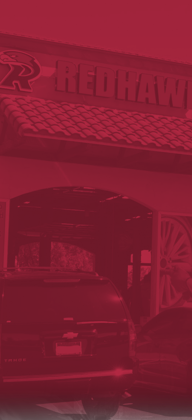 Redhawk building with red overlay background | Redhawk Auto Service