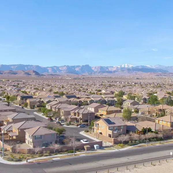 Three women are sitting on the back of a boat in the water.