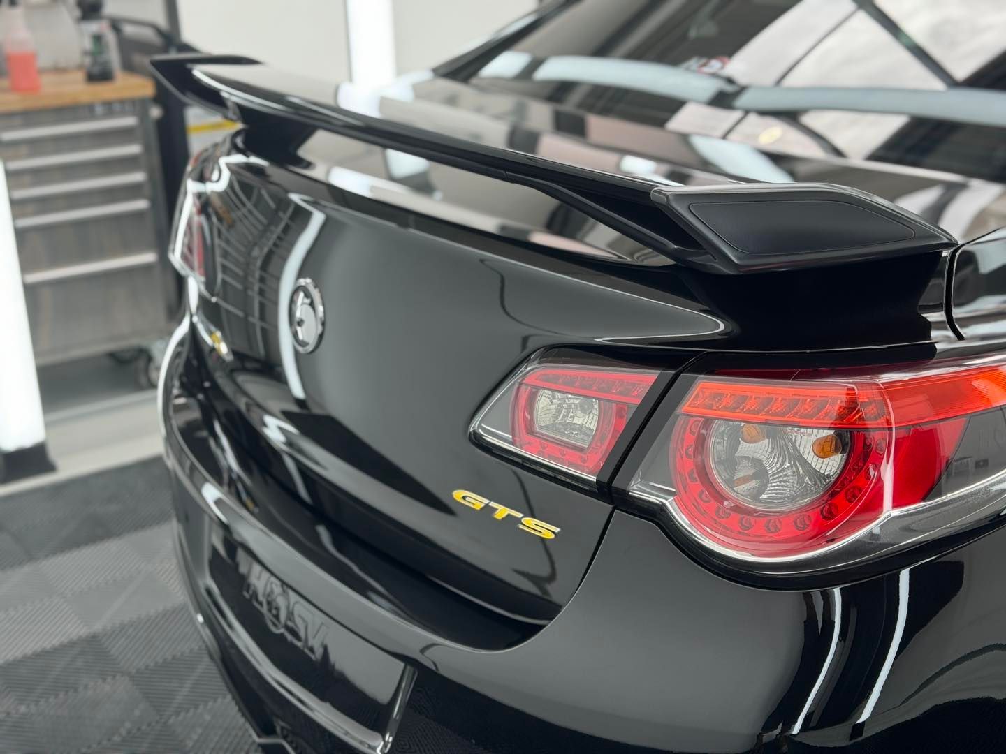 Rear View - A black car with a license plate that says elite