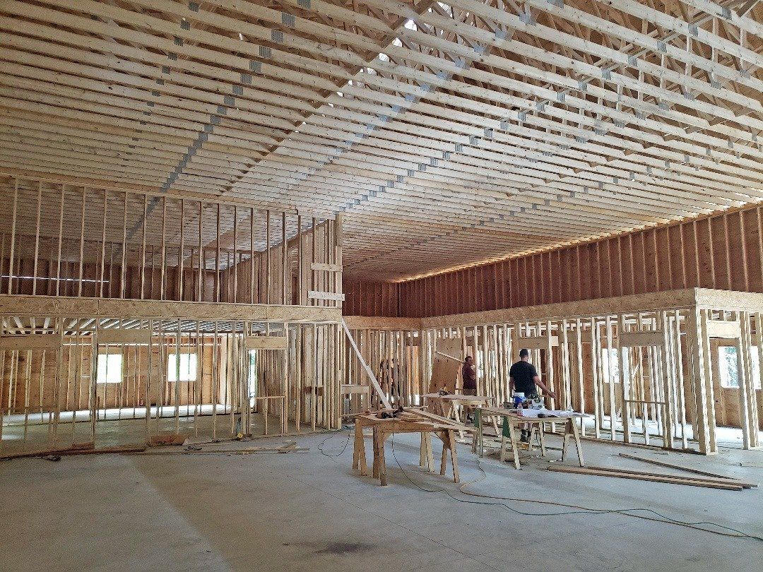 A large room with a lot of wooden beams is being built.