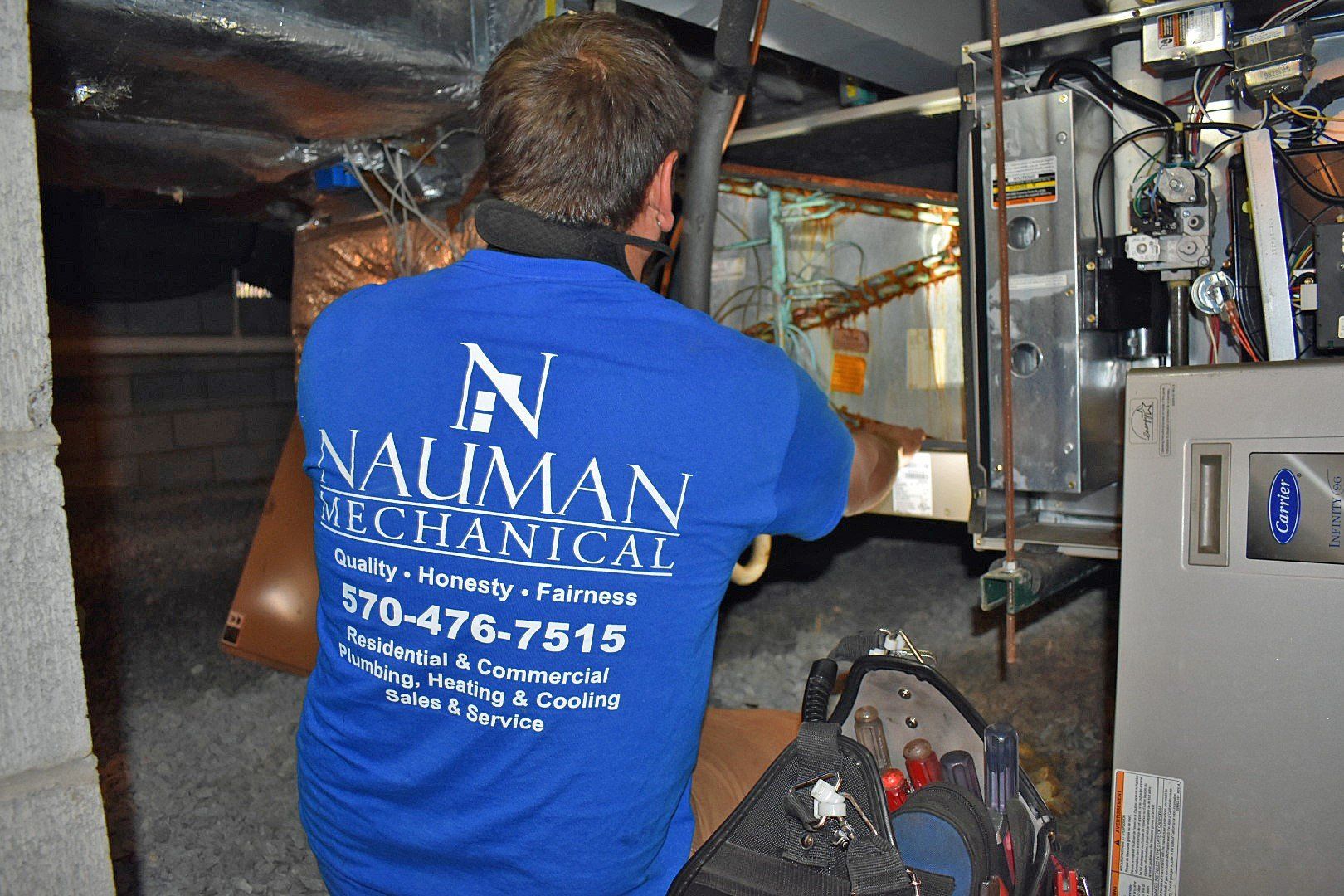 A man from Nauman Inc. wearing a blue shirt that says Nauman mechanical