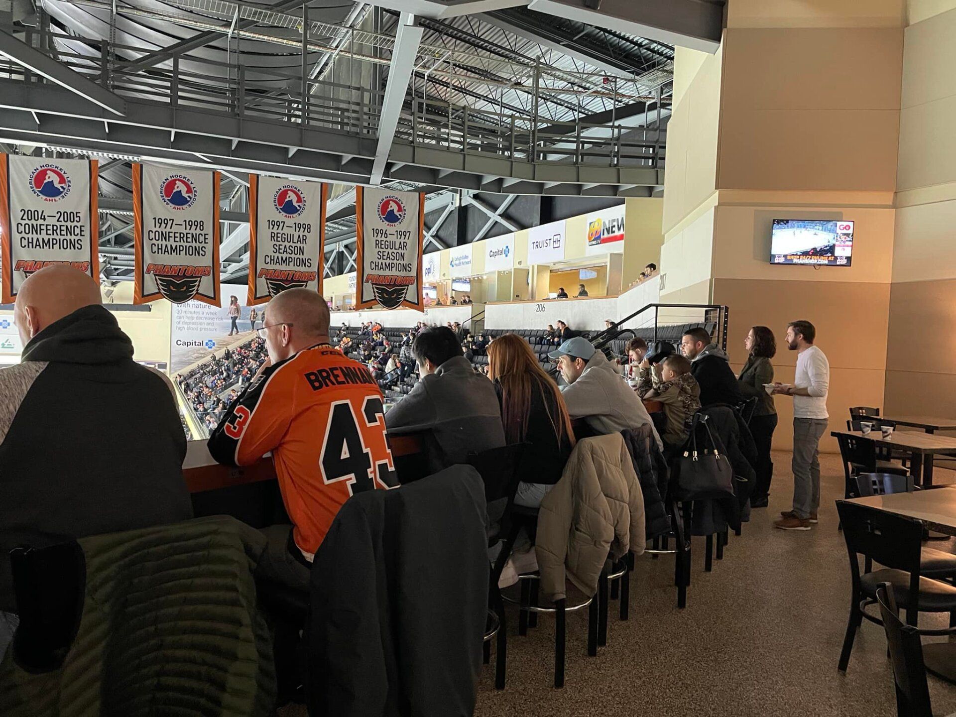 A man wearing an orange jersey with the number 43 on it