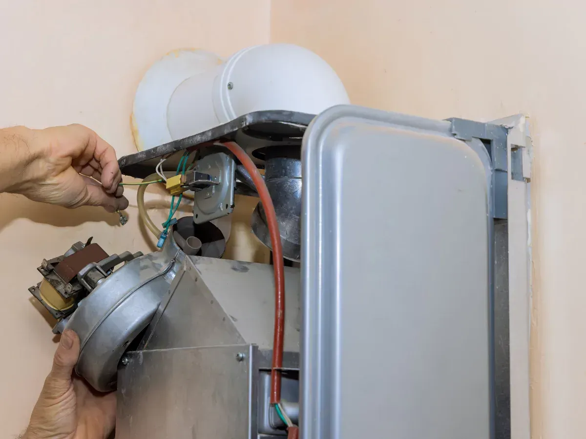 A group of Nauman Inc. workers are installing an HVAC system on top of a building.