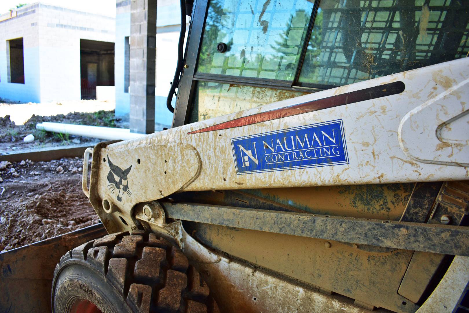 A construction machine with a sticker on the side that says nauman engineering