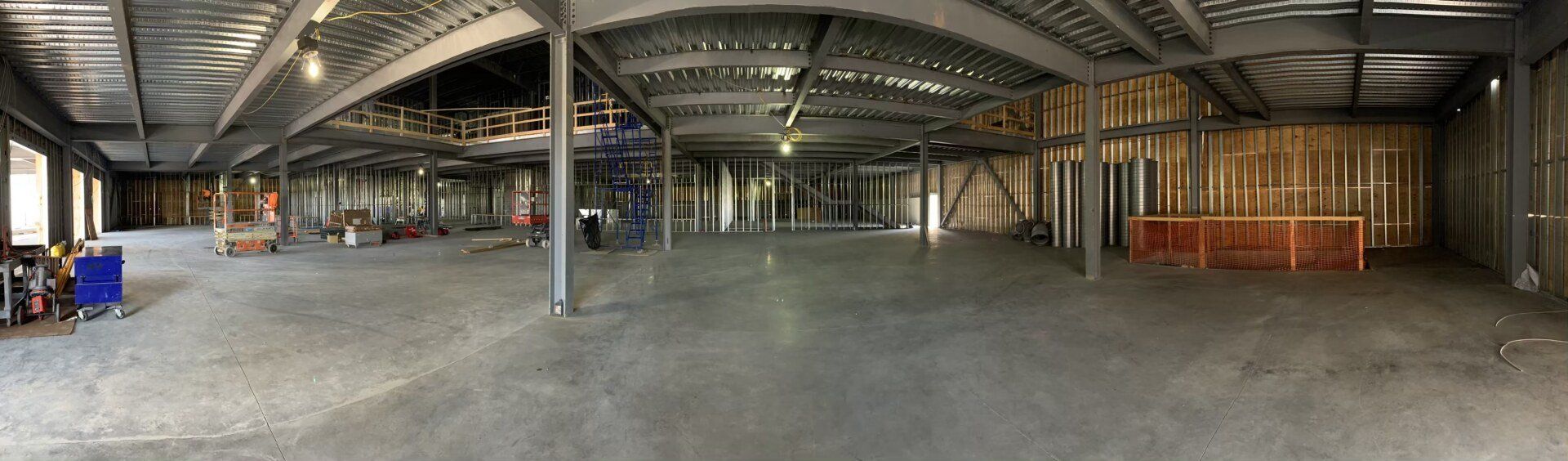 A large empty building under construction with a concrete floor.