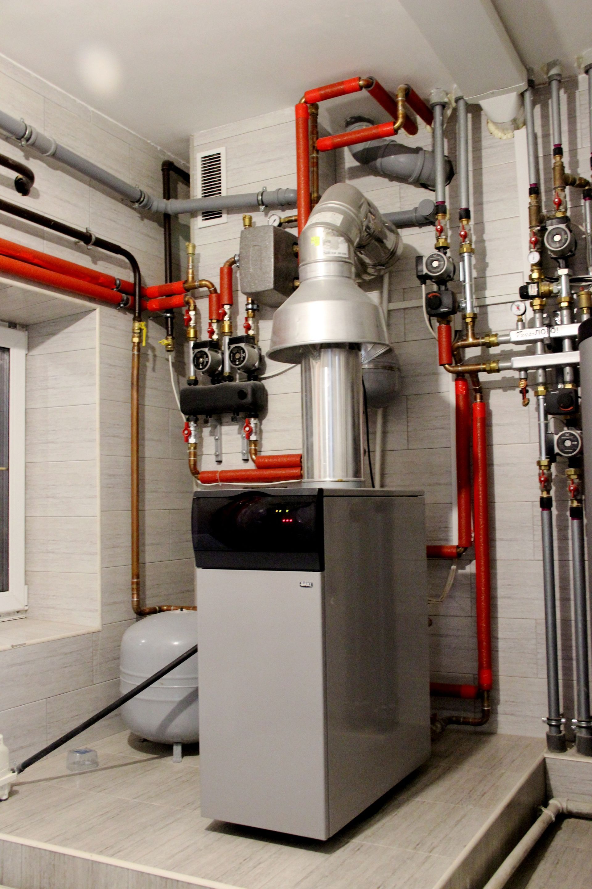 A group of Nauman Inc. workers are installing an HVAC system on top of a building.