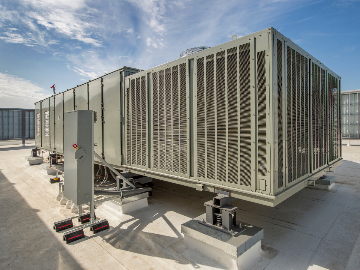 A large air conditioner is sitting on top of a roof.