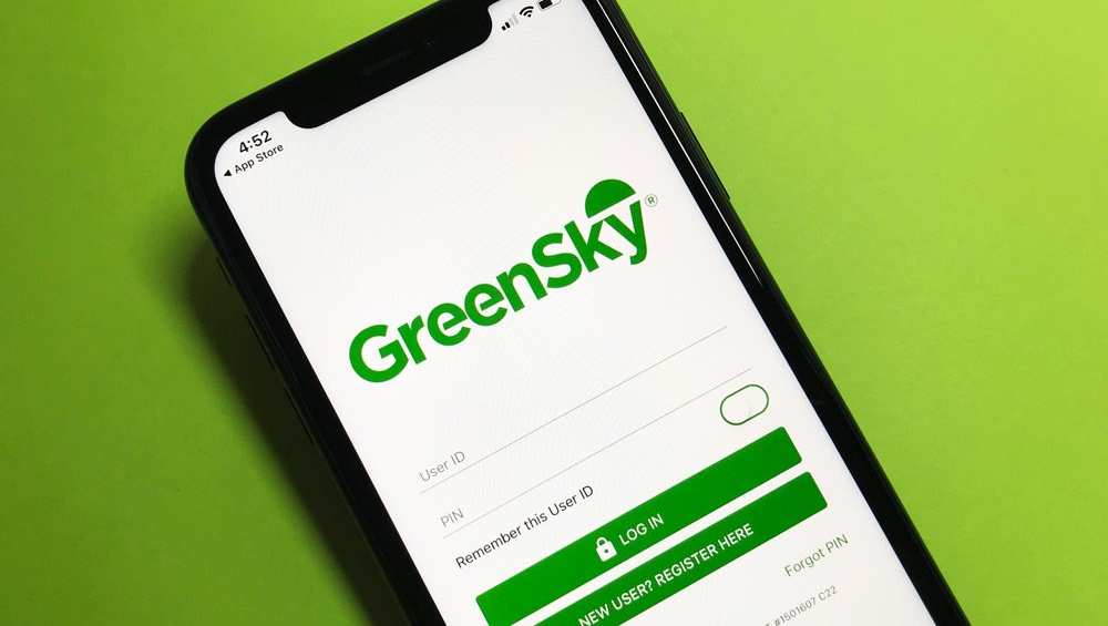 A cell phone with the green sky app open on a green background.