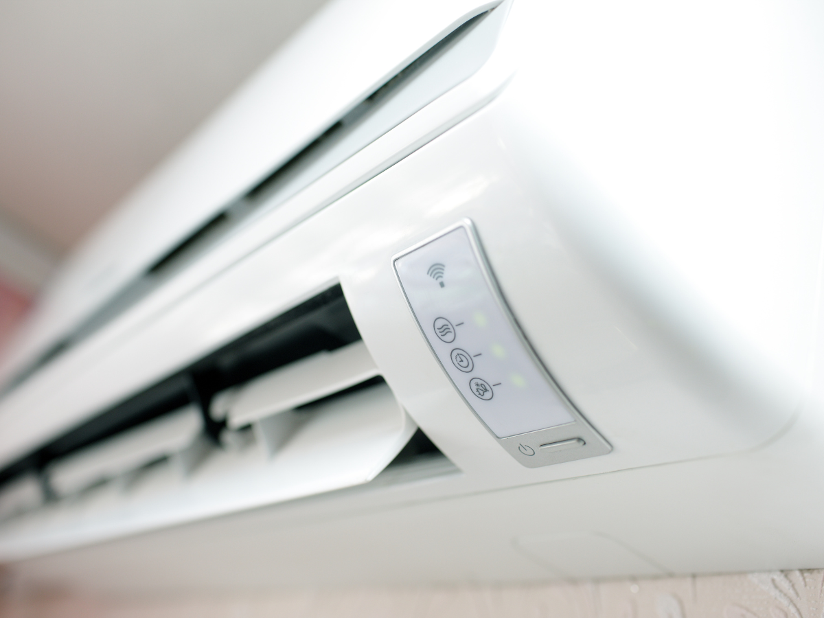 A person is adjusting a thermostat on a radiator.