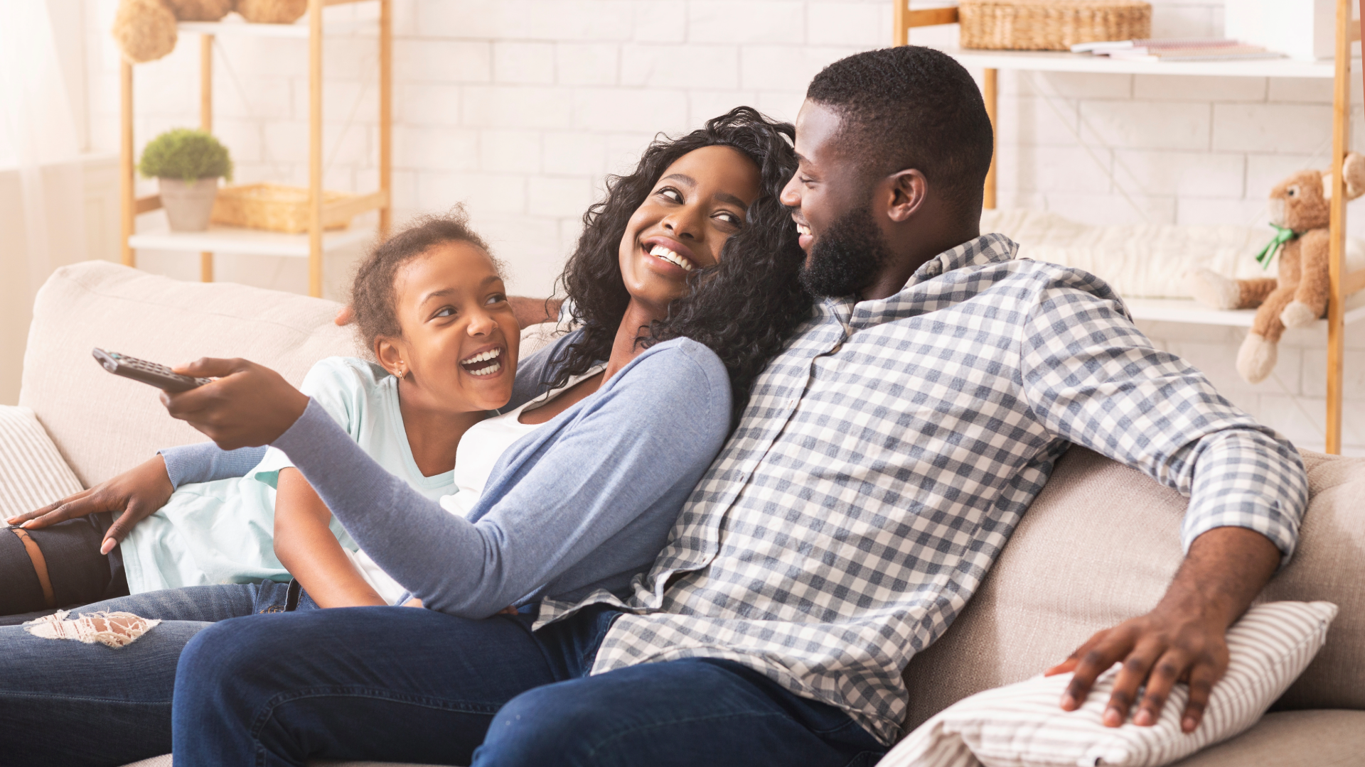 A family sitting on the couch, relaxing.