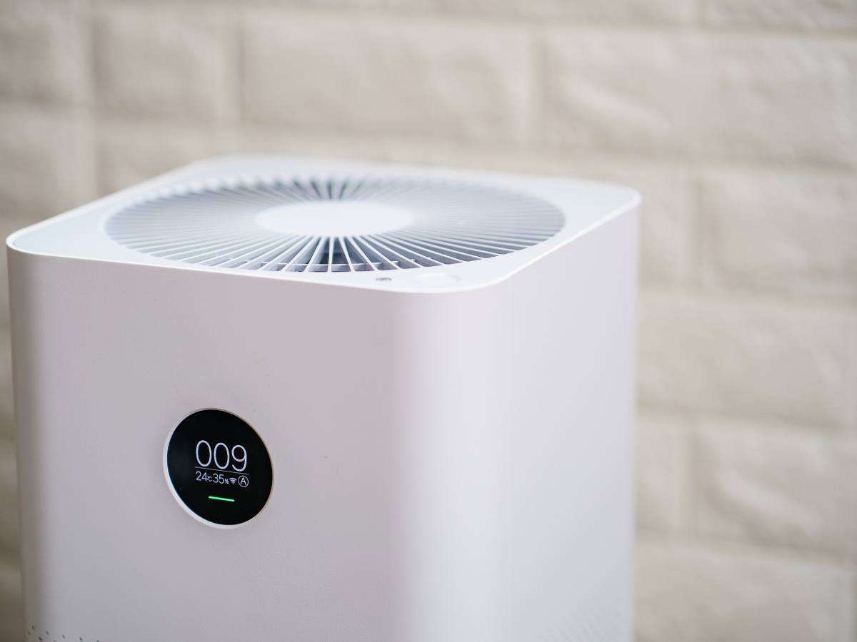 A group of Nauman Inc. workers are installing an HVAC system on top of a building.