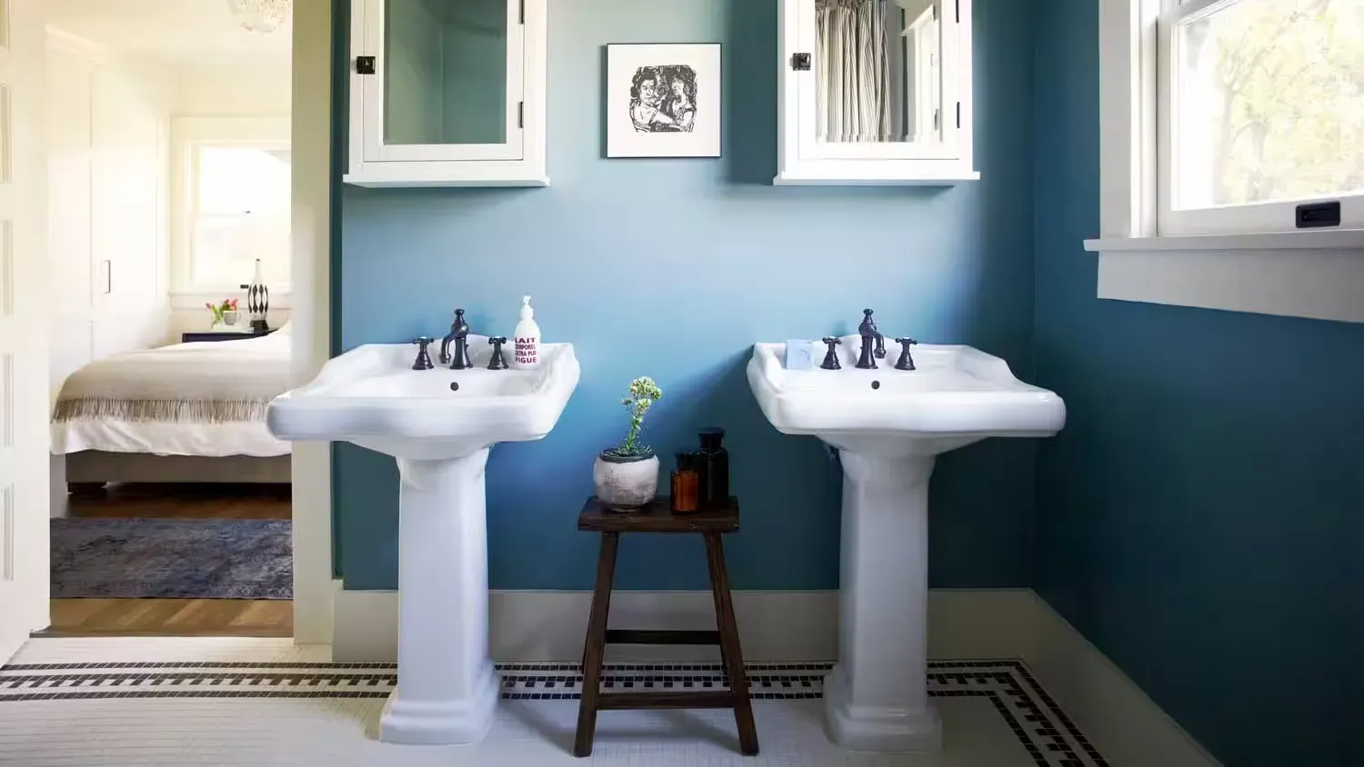 A bathroom with two sinks and a stool in it