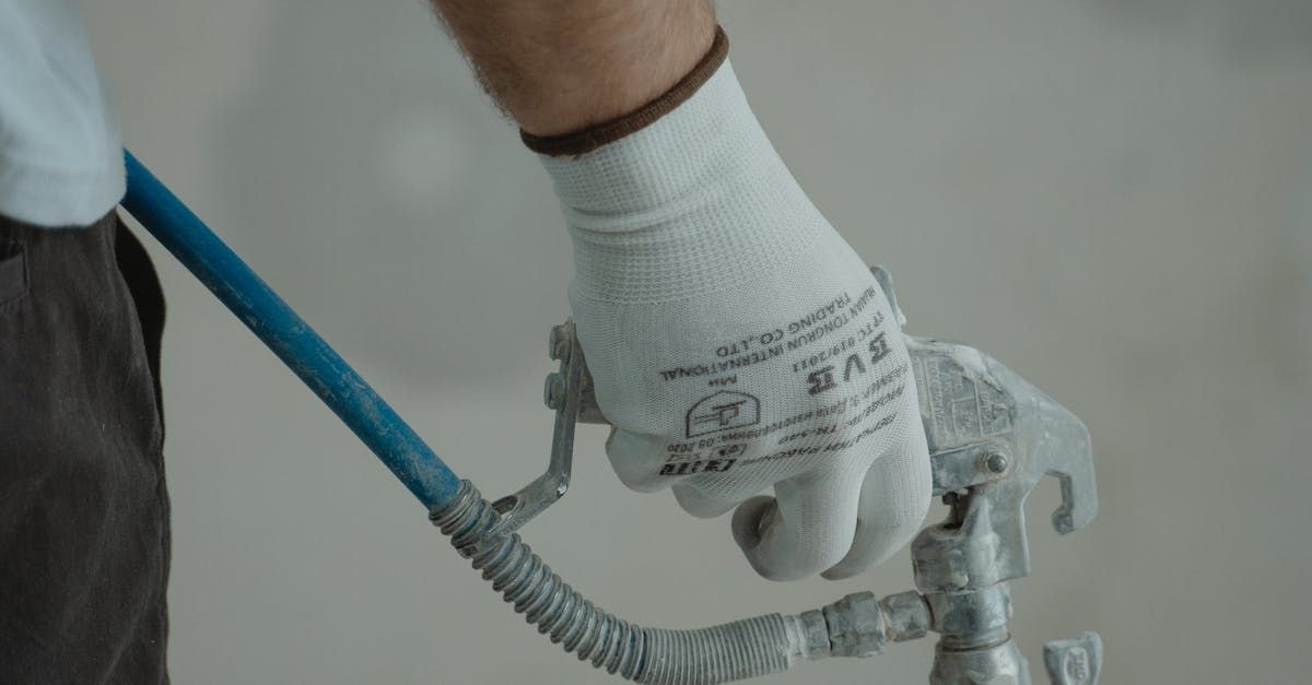 A man's hand holding a piece of plumbing equipment.