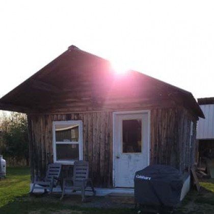 The sun is shining through the roof of a small wooden house.